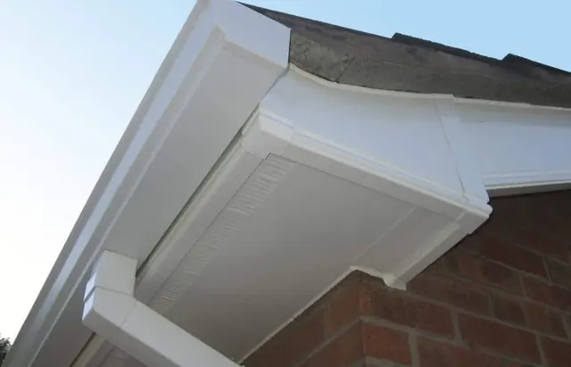 White fascia and soffit at a brick house corner