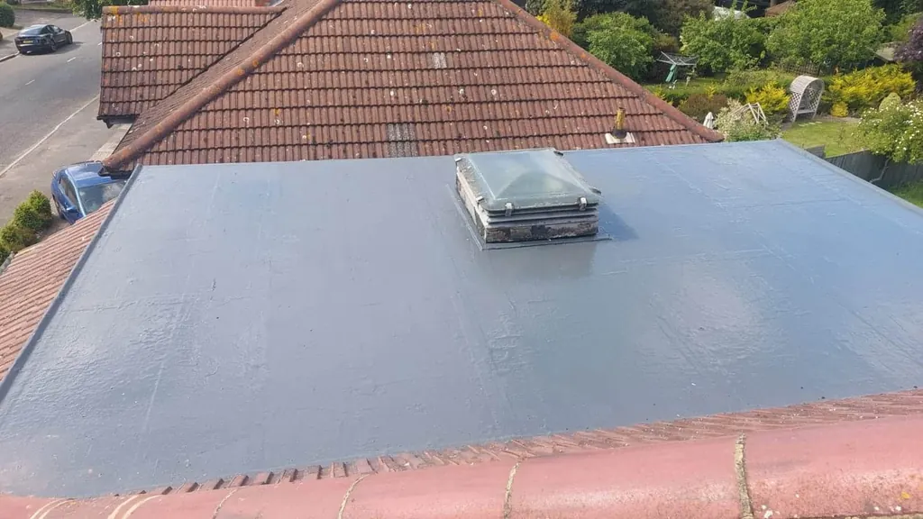 Grey flat extension roof with a small domed rooflight